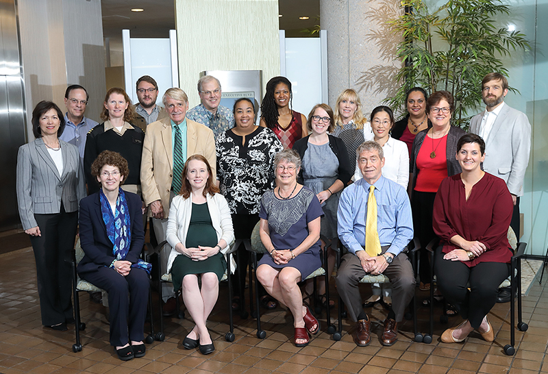 Photo of Prevention Research Coordinating Committee (PRCC) members posing in a building lobby during the June 2019 PRCC retreat.