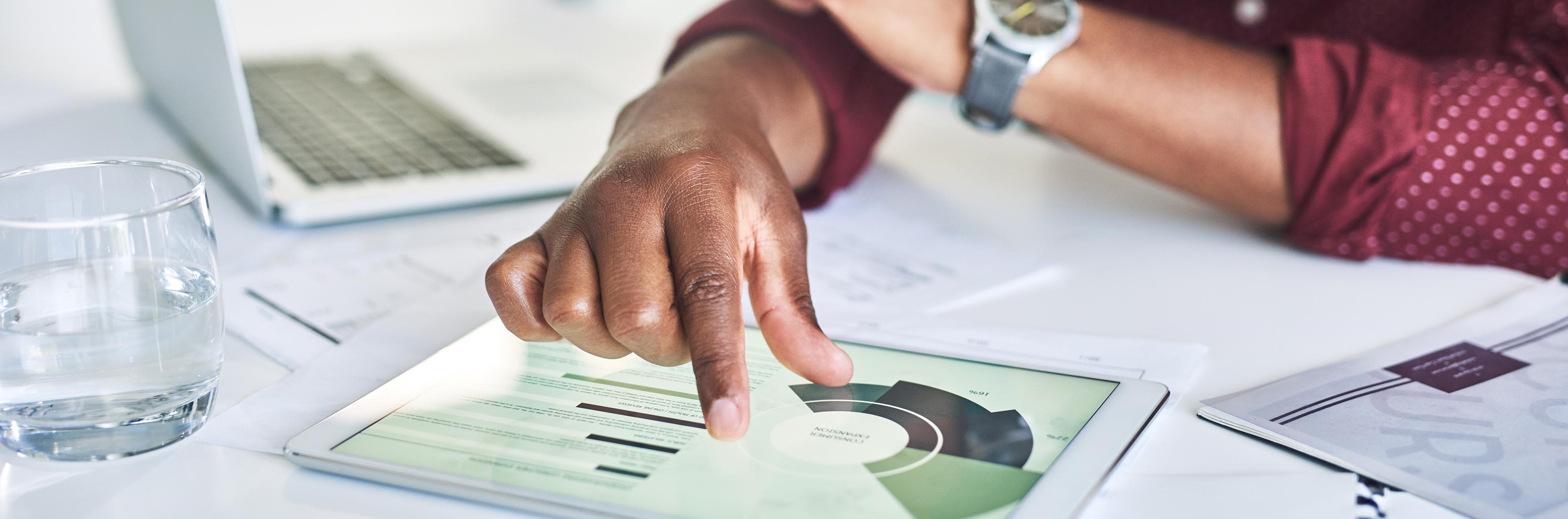 Person looking at pie charts on a tablet screen