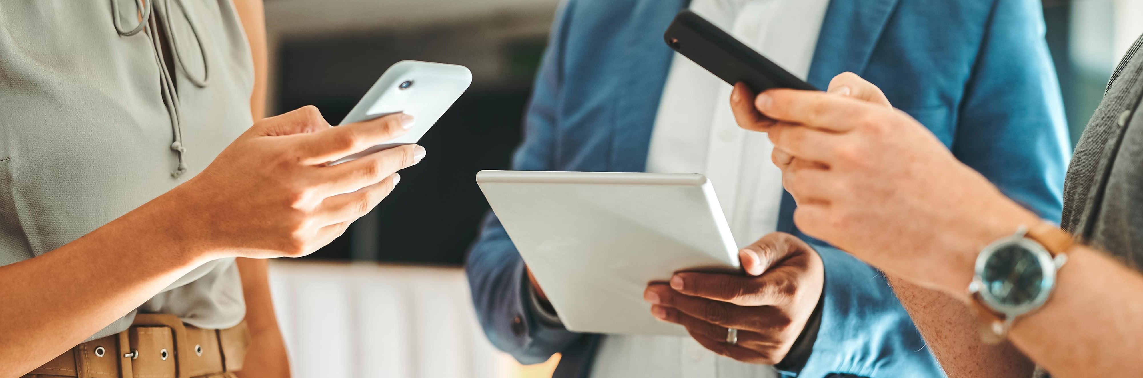 People looking at their smart devices including phones and tablets